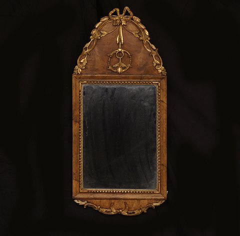 A small Louis XVI gilt walnut veneered mirror. 
Denmark circa 1780. 67x31cm