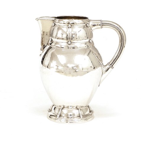 A Danish silver pitcher. Dated 1917. H: 21cm. W: 
478gr