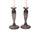 A pair of tulip shaped tin candle holders