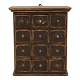 A black decorated wall-mounted cabient with 12 drawers. Denmark circa 1860-80. 
H: 61cm. W: 54cm. D: 29cm