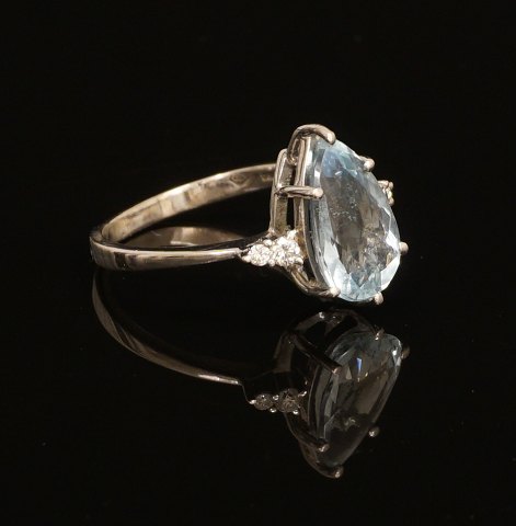 18kt hvidguld ring med akvamarin flankeret af fire diamanter. Ringstr. 56