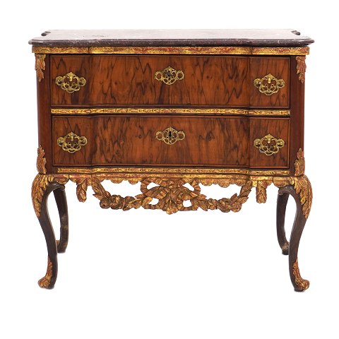 Padouk veneered and partly gilt marble top commode 
made by the manufacture Köster, Altona, 
Northgermany, circa 1770. Signed. H: 78cm. Top: 
85x44cm